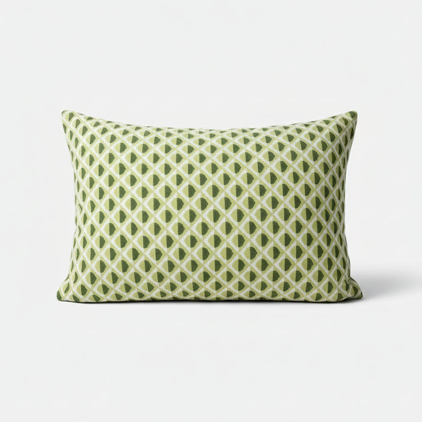 Green and white patterned pillow on a white background