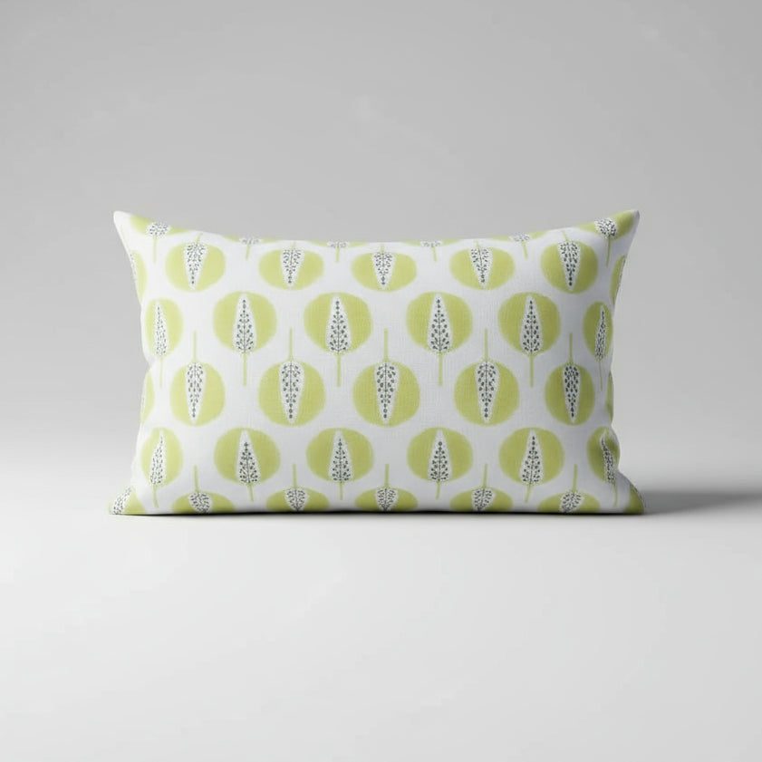 Decorative pillow with green and white pattern on a gray background